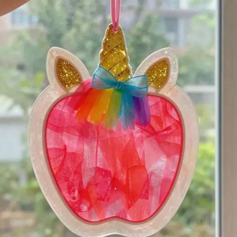 Clear pink unicorn apple teacher suncatcher made with vibrant colors.