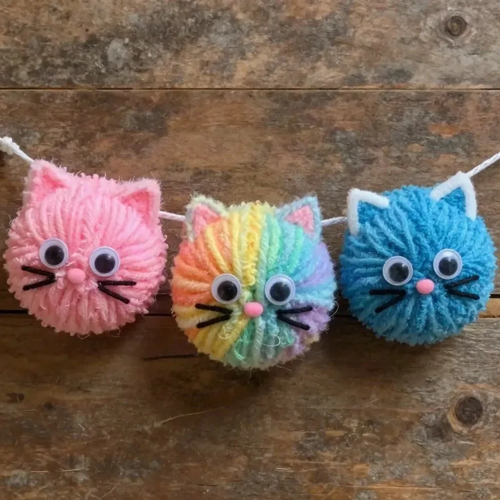 Colorful Rainbow Yarn Kitten Pom-Pom Garland for home decoration.